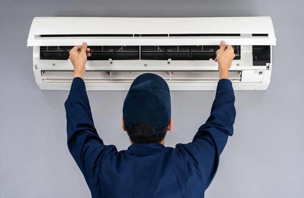 Service man checking air conditioner. Tiling Services