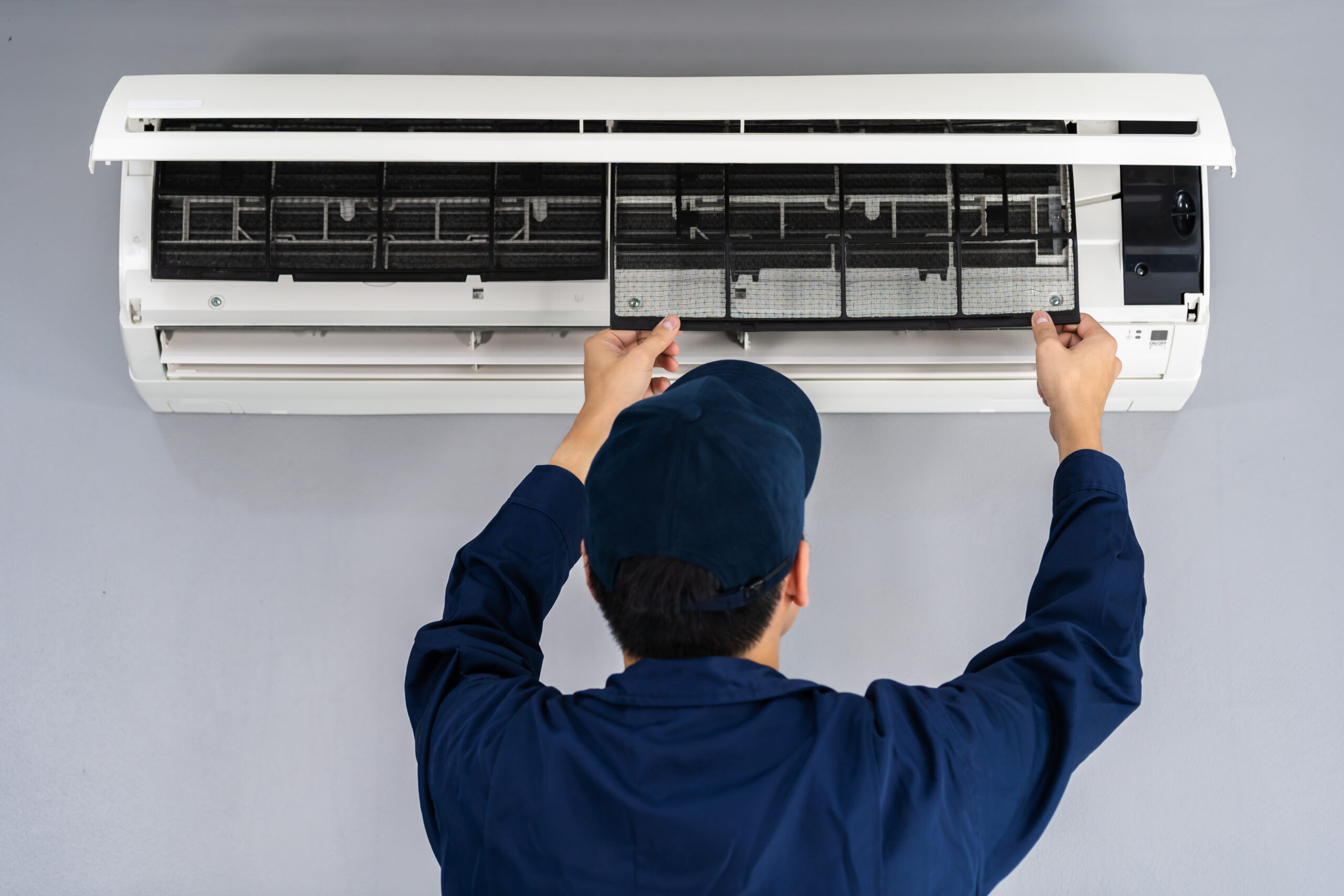 technician service removing air filter of air conditioner for cl
